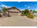 Single-story home with desert landscaping and two-car garage at 10902 E Silver Mine Rd, Gold Canyon, AZ 85118