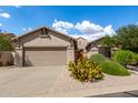 Single-story home with desert landscaping and two-car garage at 10902 E Silver Mine Rd, Gold Canyon, AZ 85118