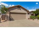 Single-story home with desert landscaping and two-car garage at 10902 E Silver Mine Rd, Gold Canyon, AZ 85118