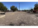 Large gravel backyard with a small shed and partial view of the street at 140 W 8Th Ave, Mesa, AZ 85210