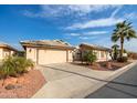 House exterior with driveway, garage, and desert landscaping at 14372 W Shawnee Trl, Surprise, AZ 85374