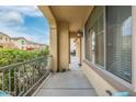 Covered front porch with light fixtures and view of the driveway at 14595 W Acapulco Ln, Surprise, AZ 85379