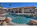 Inviting kidney-shaped pool with a large patio and mountain views at 16060 N Boulder Dr, Fountain Hills, AZ 85268