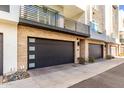 Modern garage with dark gray doors and stone exterior at 1717 E Morten Ave # 23, Phoenix, AZ 85020