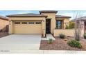 Single-story home with two-car garage and desert landscaping at 17937 W Cedarwood Ln, Goodyear, AZ 85338