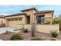 Front view of a single-story house with a two-car garage and drought-tolerant landscaping at 17937 W Cedarwood Ln, Goodyear, AZ 85338