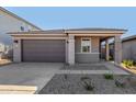 Gray house with a brown garage door and white brick accents at 18149 W Poston Dr, Surprise, AZ 85387