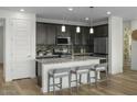Modern kitchen featuring dark cabinetry and granite countertops at 18245 W Papago St, Goodyear, AZ 85338