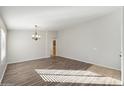 Bright dining room with hardwood floors and chandelier at 19912 N Toledo Ave, Maricopa, AZ 85138