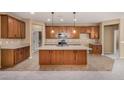 Kitchen with island, wood cabinets, and stainless steel appliances at 22378 N 184Th Ln, Surprise, AZ 85387