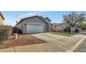 House exterior showcasing a two-car garage and a neat front yard at 225 S 123Rd Dr, Avondale, AZ 85323