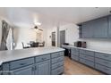 Eat-in kitchen with gray cabinets, island, and wood flooring at 255 N Hunt E Dr, Mesa, AZ 85203