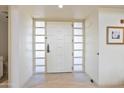 Modern entryway with a white door and glass panels at 2802 E Camino Acequia Dr # 75, Phoenix, AZ 85016