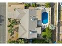 An aerial view showcasing a single-Gathering home with a pool and surrounding landscape at 2856 E Cochise Rd, Phoenix, AZ 85028