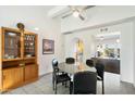Dining room with a mid-century modern style table and chairs, and a wood cabinet at 2856 E Cochise Rd, Phoenix, AZ 85028