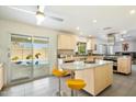 Bright kitchen with island, stainless steel appliances and pool view from sliding door at 2856 E Cochise Rd, Phoenix, AZ 85028