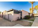 Another view of the tan stucco house and gated entrance at 5984 W Augusta Ave, Glendale, AZ 85301