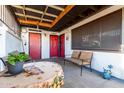 Covered patio with seating and a red door entrance at 5984 W Augusta Ave, Glendale, AZ 85301