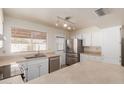 Spacious kitchen with island, stainless steel appliances, and white cabinets at 7202 W Carol Ave, Peoria, AZ 85345