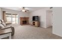 Living room features a brick fireplace, sliding glass door, and neutral carpeting at 7202 W Carol Ave, Peoria, AZ 85345