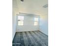 Bedroom featuring plush grey carpeting, recessed lighting, and dual windows for ample natural light at 7802 E Quintana Ave, Mesa, AZ 85212