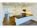 Modern kitchen featuring white cabinets, black countertops, and stainless steel appliances at 7802 E Quintana Ave, Mesa, AZ 85212