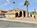Two-story house with three-car garage and desert landscaping at 938 W Iris Dr, Gilbert, AZ 85233