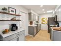 Modern kitchen with gray cabinets and marble countertops at 10529 W Palmeras Dr, Sun City, AZ 85373