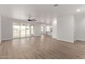 Spacious living room featuring hardwood floors and sliding glass doors at 10662 S 297Th Ave, Palo Verde, AZ 85343