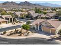 House with mountain views and desert landscaping at 10724 S Mustang Dr, Goodyear, AZ 85338