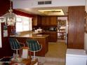 Well-equipped kitchen with dark wood cabinets and granite countertops at 11051 N 53Rd Ave, Glendale, AZ 85304