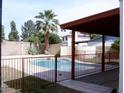 Inviting backyard pool with a metal fence and covered patio at 11051 N 53Rd Ave, Glendale, AZ 85304