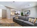 Open living area with gray sectional sofa and kitchen views at 11683 N 135Th Pl, Scottsdale, AZ 85259