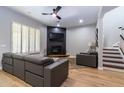 Living room with gray sectional and a modern fireplace at 11683 N 135Th Pl, Scottsdale, AZ 85259