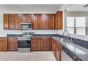 Spacious kitchen featuring dark wood cabinets and granite countertops at 11820 W Monte Lindo Ln, Sun City, AZ 85373