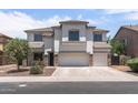 Two-story house with a three-car garage and front yard landscaping at 11860 W Grant St, Avondale, AZ 85323