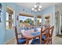 Bright dining area with wood table and chairs, offering a view of the backyard at 11930 W Monroe St, Avondale, AZ 85323