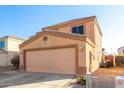 Two-story house with a large garage and desert landscaping at 12305 W Flores Dr, El Mirage, AZ 85335