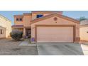 Two-story house with a large garage and desert landscaping at 12305 W Flores Dr, El Mirage, AZ 85335