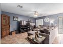 Spacious living room with L-shaped sectional sofa and large TV at 12305 W Flores Dr, El Mirage, AZ 85335