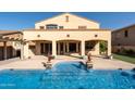 Inviting backyard oasis featuring a sparkling pool and spacious patio at 13347 W Via Caballo Blanco --, Peoria, AZ 85383