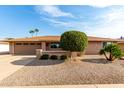 Single story house with a two-car garage and mature landscaping at 13438 W Ashwood Dr, Sun City West, AZ 85375