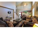 High ceiling living room, featuring a large window and staircase at 1406 S Navajo Ln, Coolidge, AZ 85128