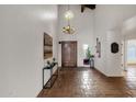 Bright entryway with tile flooring, a wood door and chandelier at 16544 E Trevino Dr, Fountain Hills, AZ 85268