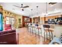 Kitchen with an island, wooden cabinets and breakfast bar at 17203 E Calaveras Ave, Fountain Hills, AZ 85268