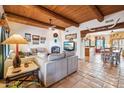 Spacious living room with a fireplace and wood beam ceilings at 17203 E Calaveras Ave, Fountain Hills, AZ 85268