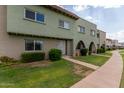 View of townhome building, showing landscaping and walkway at 225 N Standage -- # 122, Mesa, AZ 85201