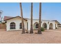 Ranch style home with three palm trees in front at 2407 E Encanto St, Mesa, AZ 85213