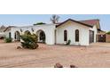 White house with a dark brown garage door and shrubs at 2407 E Encanto St, Mesa, AZ 85213