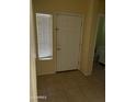 Inviting entryway with tile flooring and a view of a half bathroom at 2431 N 83Rd Dr, Phoenix, AZ 85037